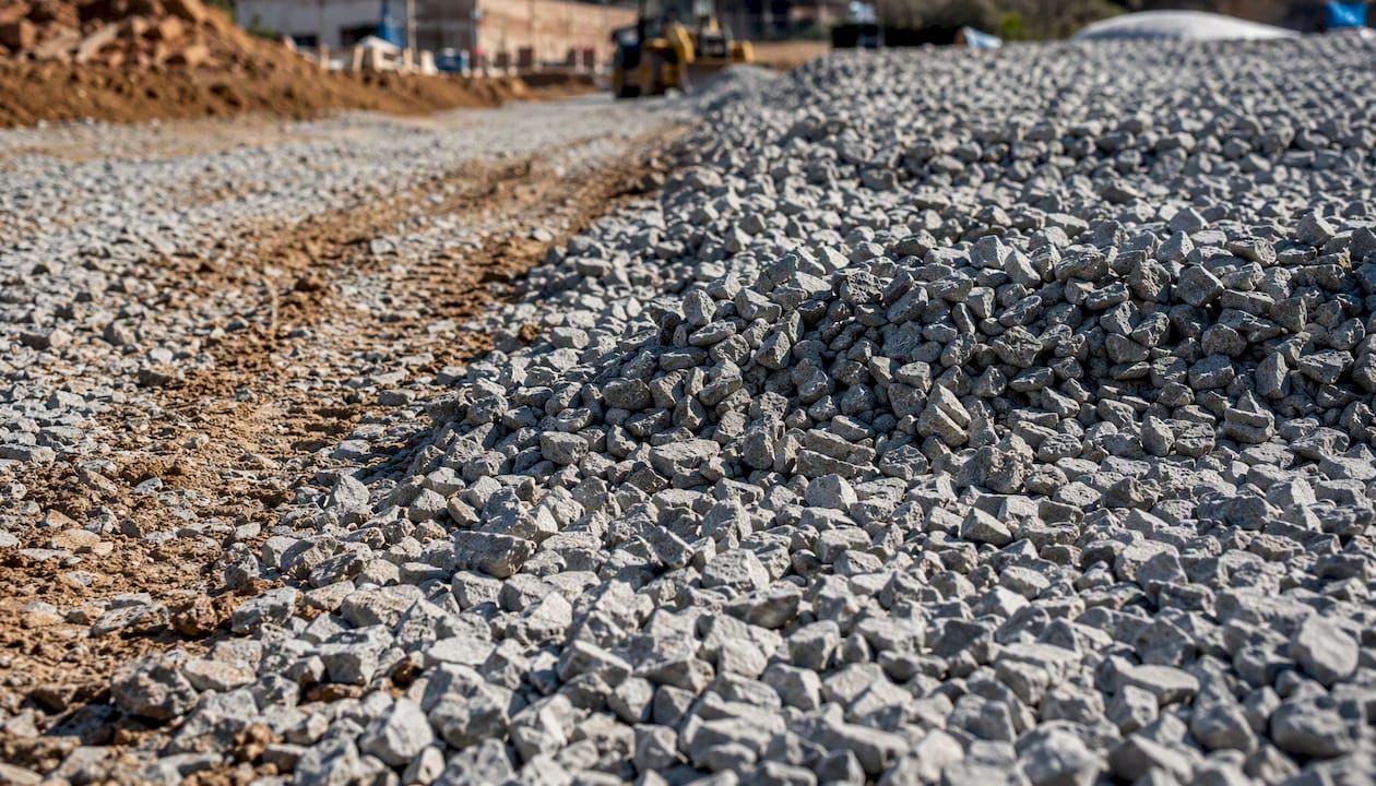Layered crushed stone driveway base construction close-up